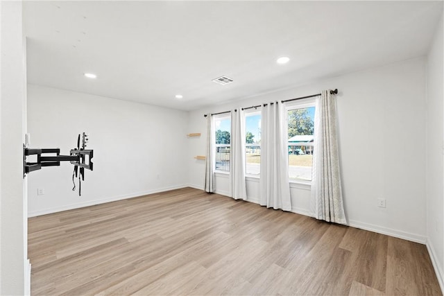 unfurnished room featuring light hardwood / wood-style floors