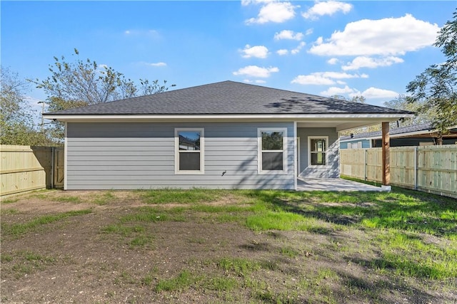 rear view of property featuring a patio area and a lawn