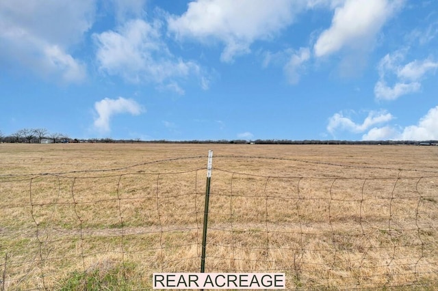 view of yard with a rural view