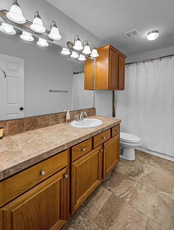 bathroom with vanity and toilet