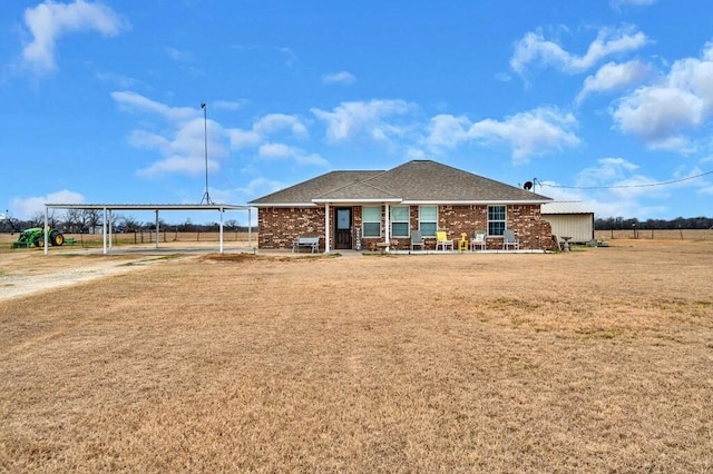 rear view of property featuring a yard