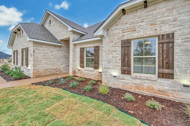 doorway to property with a lawn