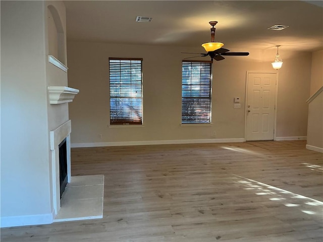 unfurnished living room featuring light hardwood / wood-style floors and ceiling fan