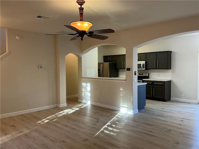 unfurnished living room with ceiling fan and light wood-type flooring