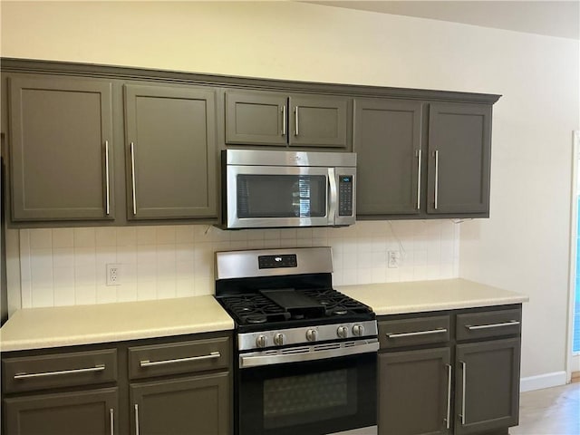 kitchen featuring decorative backsplash and appliances with stainless steel finishes