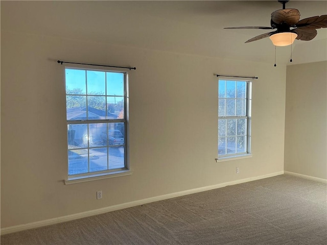 spare room with carpet flooring, plenty of natural light, and ceiling fan