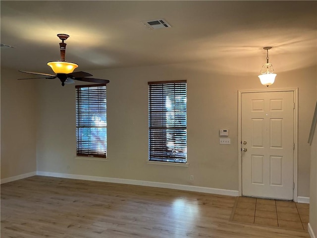 entrance foyer with ceiling fan and light hardwood / wood-style floors