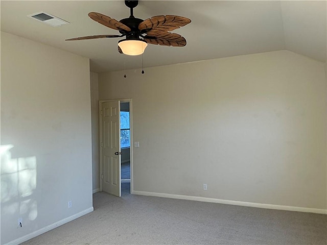 carpeted empty room with ceiling fan and vaulted ceiling