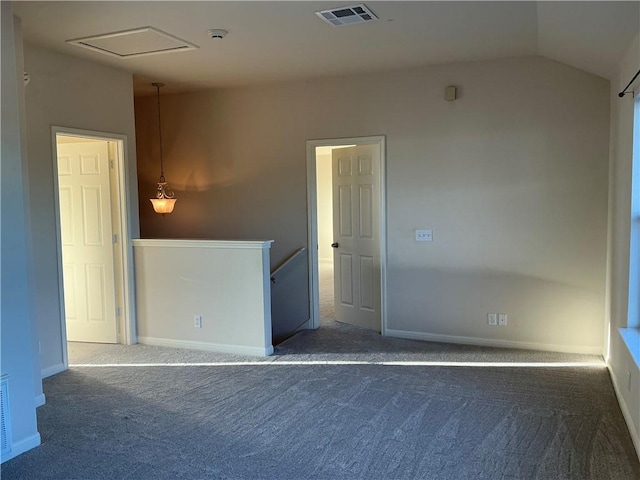 carpeted empty room with lofted ceiling