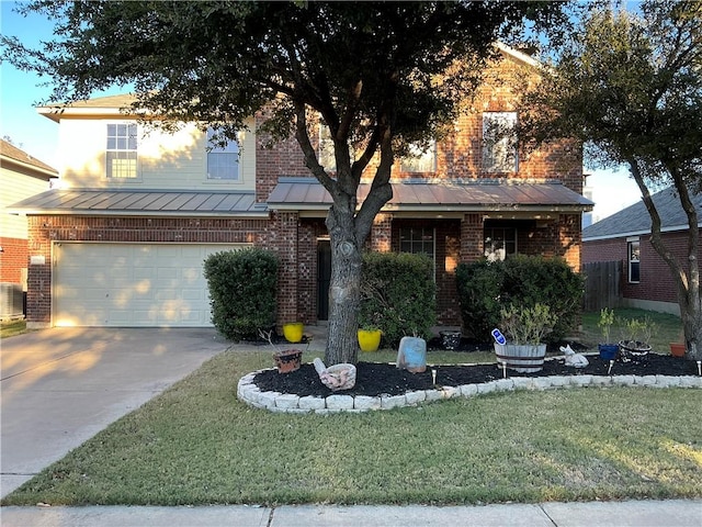 view of front facade featuring a front yard, central AC, and a garage