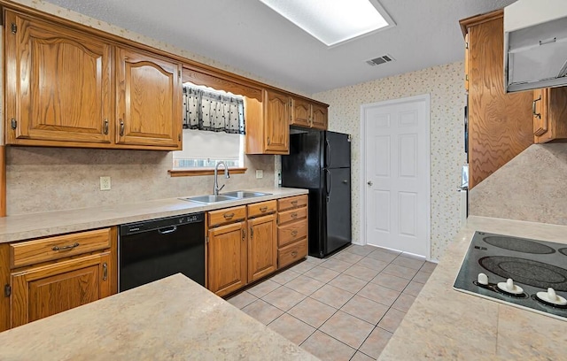 kitchen with sink, light tile patterned floors, decorative backsplash, and black appliances