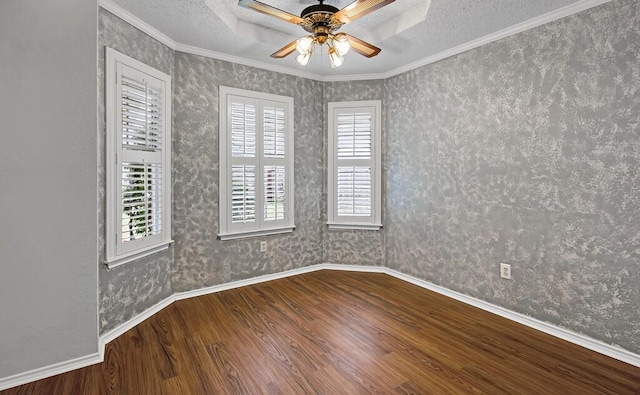 spare room featuring crown molding, a textured ceiling, wood-type flooring, and ceiling fan