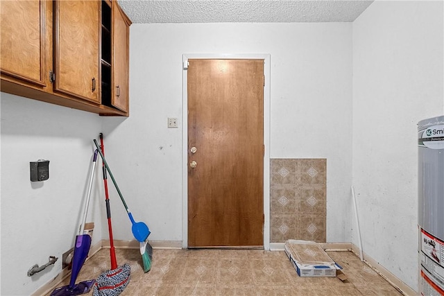 washroom with cabinets and a textured ceiling