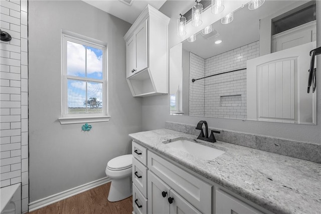 bathroom with hardwood / wood-style floors, vanity, and toilet