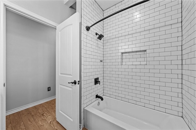 bathroom featuring hardwood / wood-style floors and tiled shower / bath combo