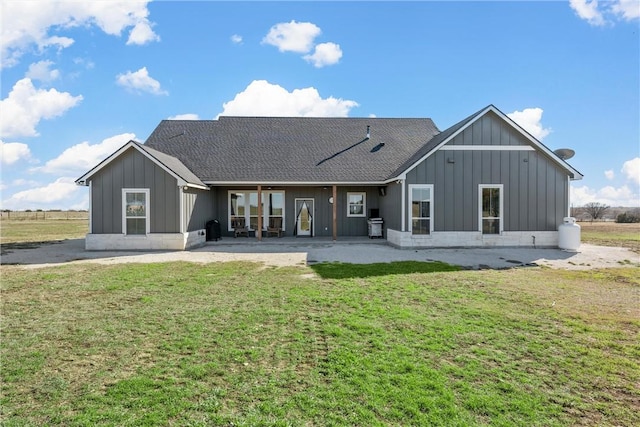 rear view of property with a yard and a patio