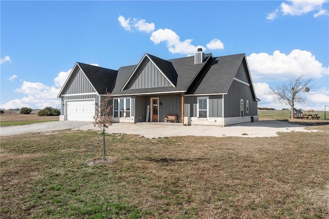 view of front facade with a front yard and a garage