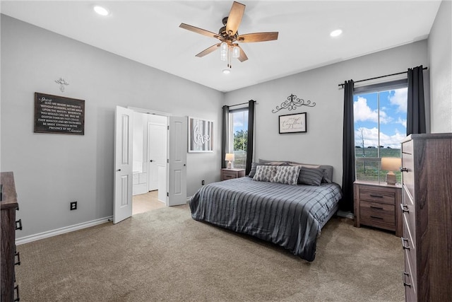 carpeted bedroom with ceiling fan and multiple windows