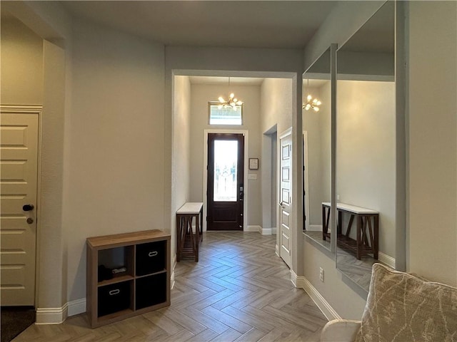 entrance foyer featuring parquet flooring and a chandelier