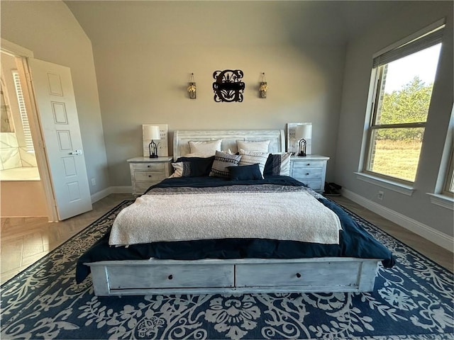 bedroom with wood-type flooring and lofted ceiling