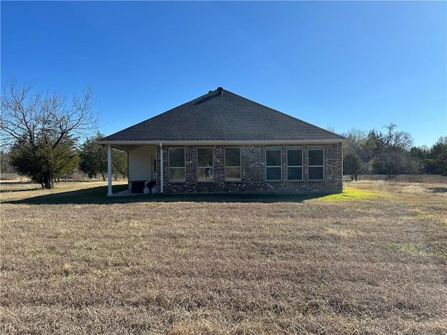 rear view of house with a yard