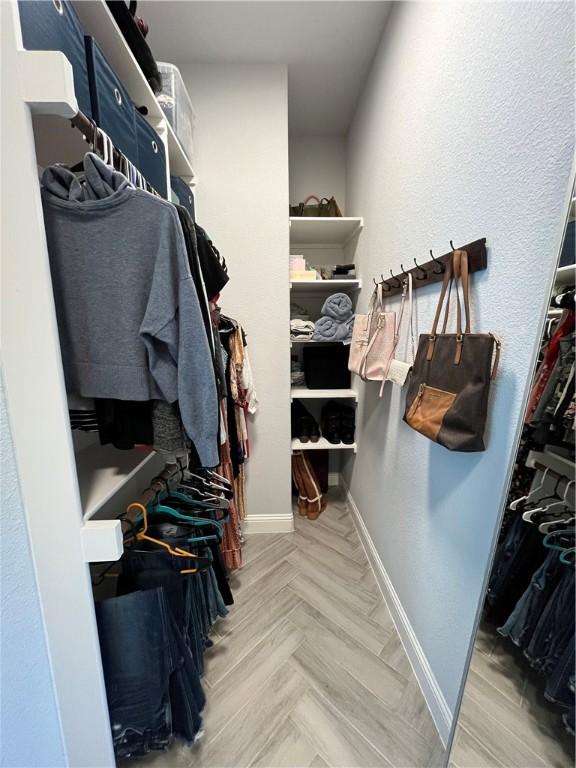 spacious closet with parquet floors