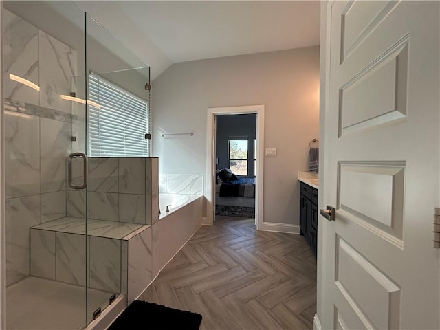 bathroom with parquet flooring, vanity, vaulted ceiling, and independent shower and bath