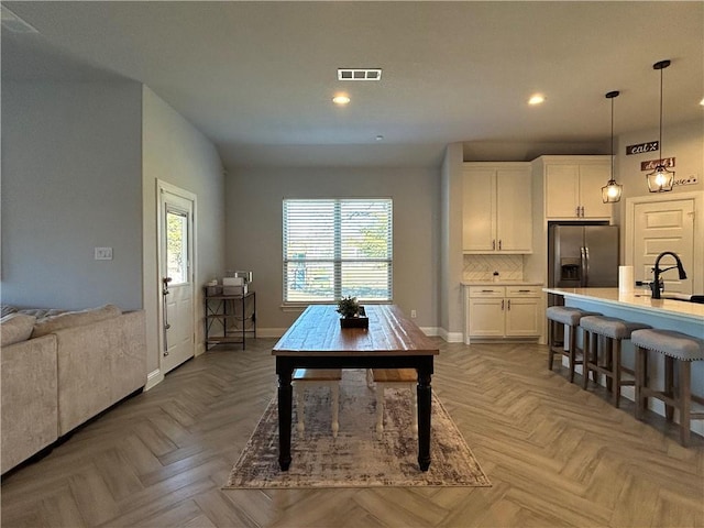 dining area with parquet floors and sink