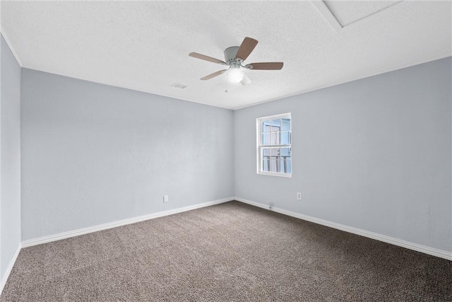 spare room featuring carpet, a textured ceiling, and ceiling fan