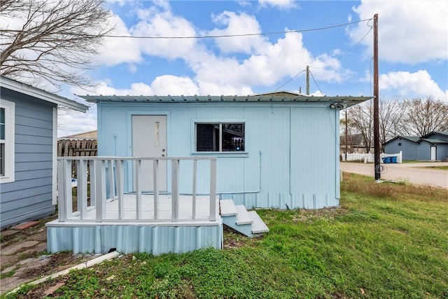 view of outbuilding featuring a lawn