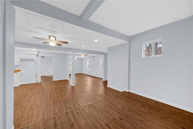 unfurnished living room featuring ceiling fan and hardwood / wood-style floors