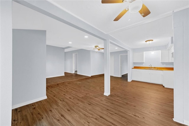 unfurnished living room featuring hardwood / wood-style floors and sink