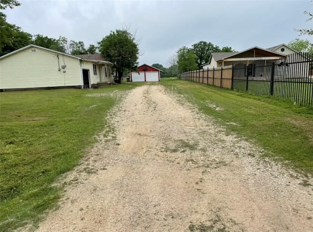 exterior space with a garage and an outbuilding