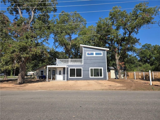 view of front of house featuring a balcony