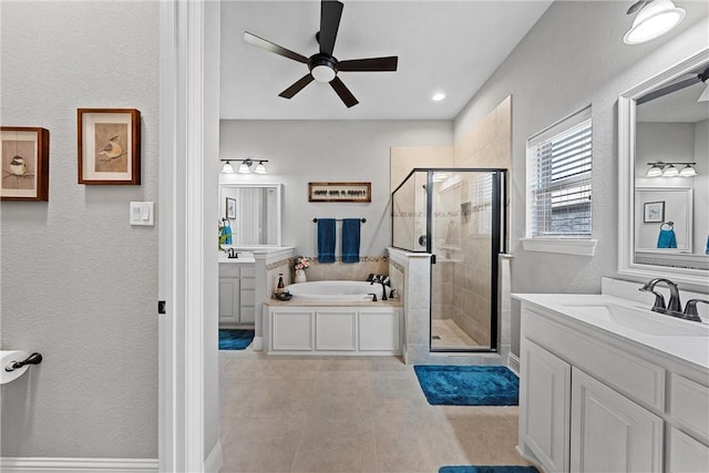 bathroom featuring ceiling fan, vanity, and independent shower and bath