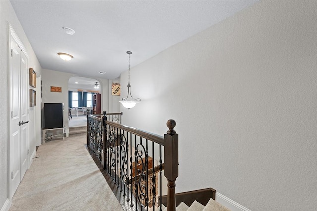 hallway featuring light colored carpet