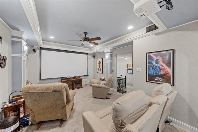 cinema with decorative columns, light carpet, ceiling fan, and ornamental molding