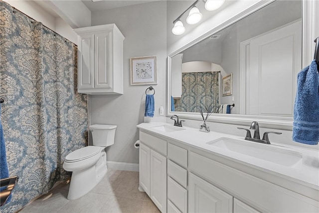 bathroom featuring tile patterned floors, vanity, and toilet