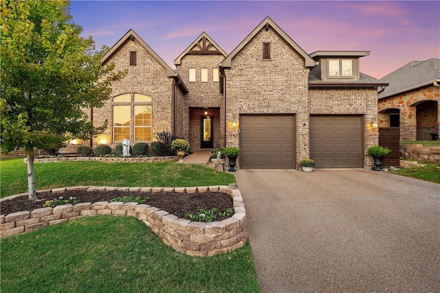 view of front of property with a garage and a yard