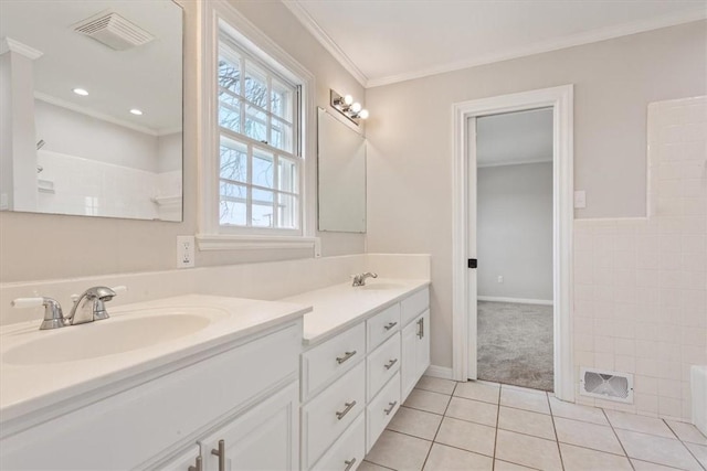 full bath with crown molding, visible vents, a sink, and tile patterned floors