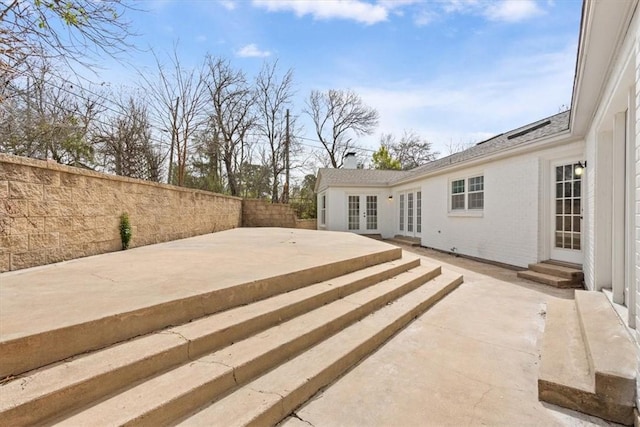 view of patio / terrace with entry steps, french doors, and a fenced backyard