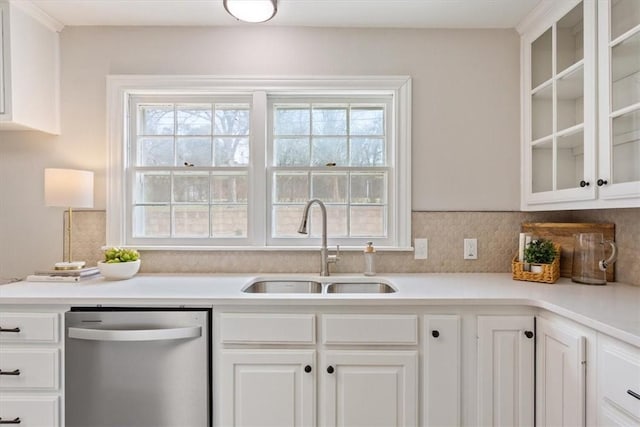 kitchen featuring light countertops, glass insert cabinets, white cabinets, a sink, and dishwasher