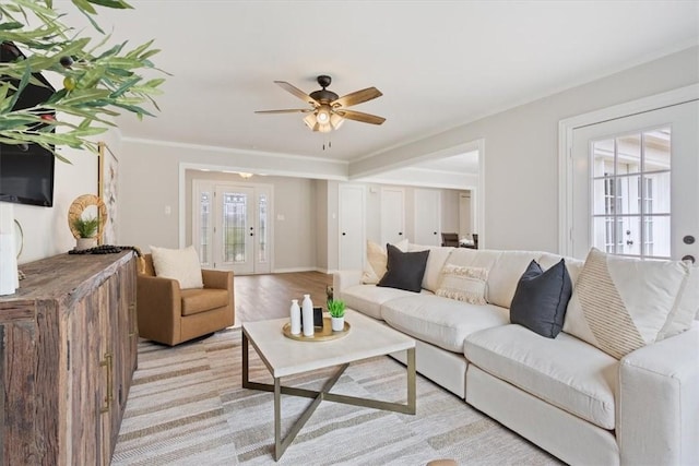 living room featuring ornamental molding, a wealth of natural light, and ceiling fan