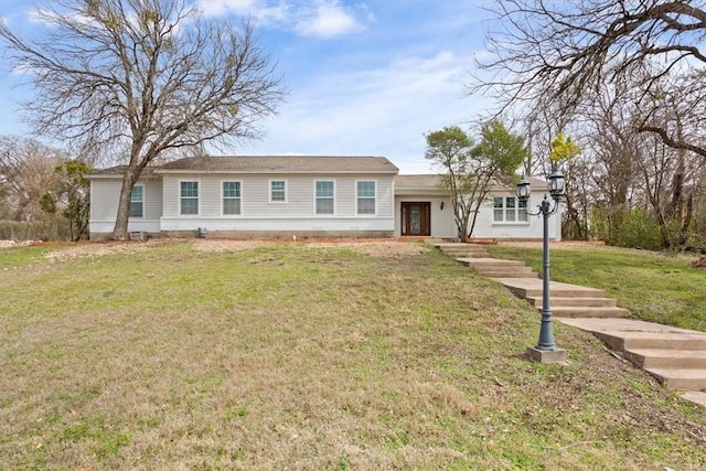 ranch-style home with a front lawn