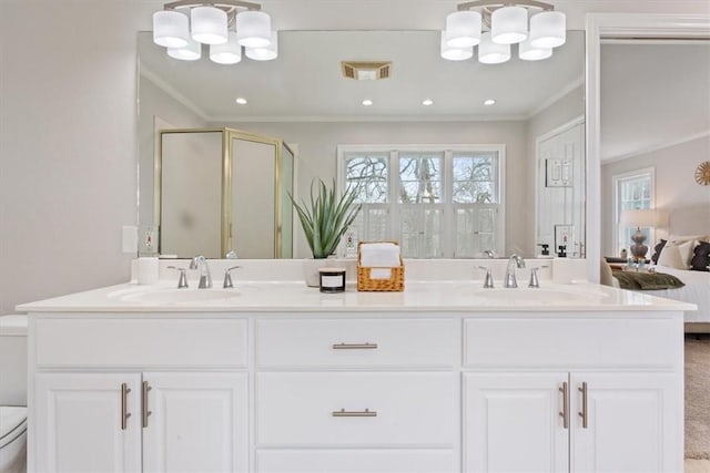 bathroom with visible vents, a sink, toilet, and an inviting chandelier