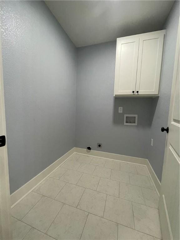 washroom featuring hookup for a washing machine, light tile patterned floors, cabinets, and hookup for an electric dryer