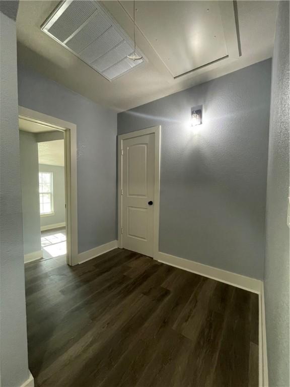 spare room featuring dark wood-type flooring