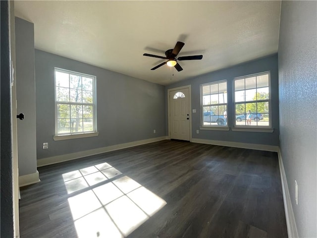 foyer featuring ceiling fan and dark wood-type flooring