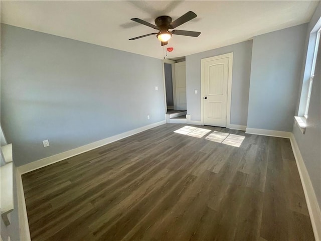 unfurnished bedroom with dark hardwood / wood-style flooring, a closet, and ceiling fan