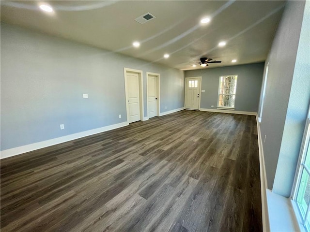 empty room featuring ceiling fan and dark hardwood / wood-style flooring